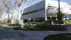 A white Building next to a tree at the College of the Canyons Honor Grove.